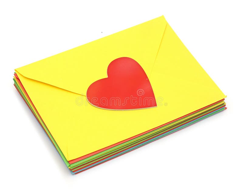 A red heart on pile colorful envelopes