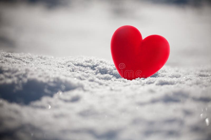 Red heart on snow