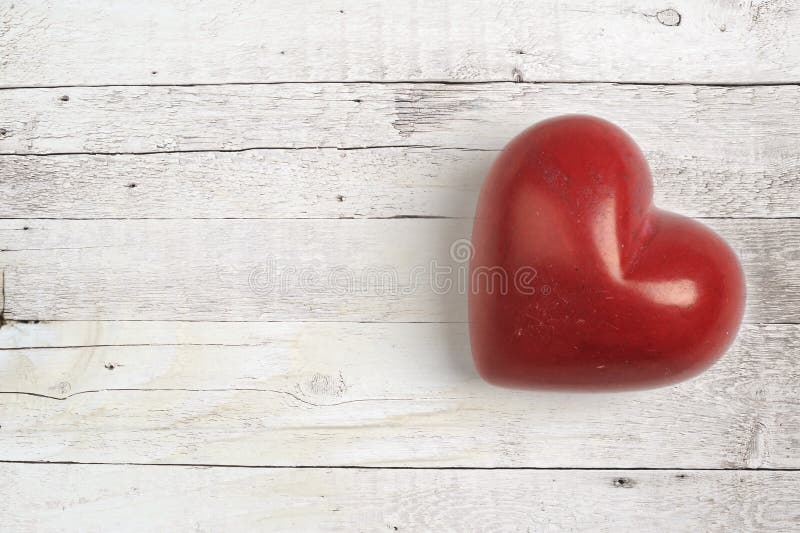 Red heart on a wooden table