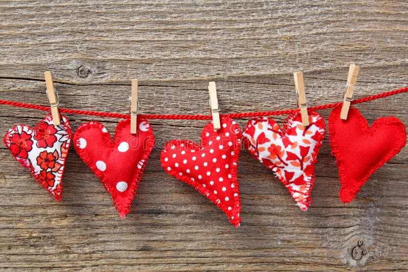 Red hearts hanging on line