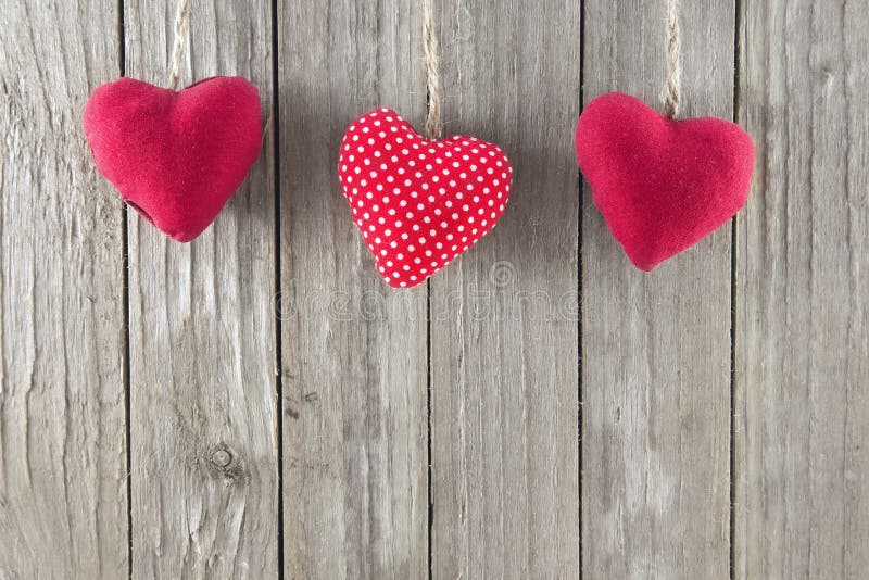 Red Hearts. Three red hearts on a wooden background stock image Red Hearts. Three red hearts on a wooden background stock image
