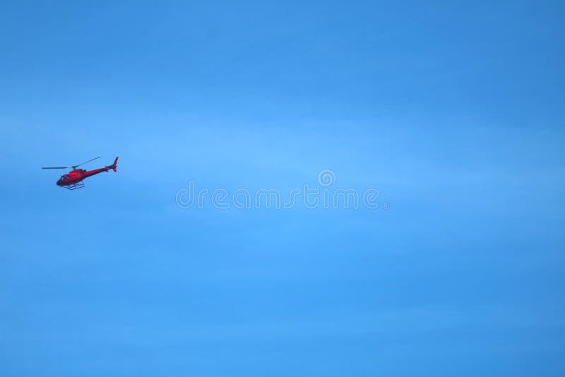 Red helicopter flying across vibrant blue sky of Rio de Janeiro, Brazil stock images Red helicopter flying across vibrant blue sky of Rio de Janeiro, Brazil stock images