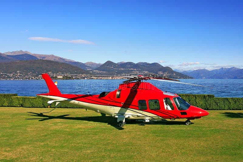 Red helicopter on the landing field.