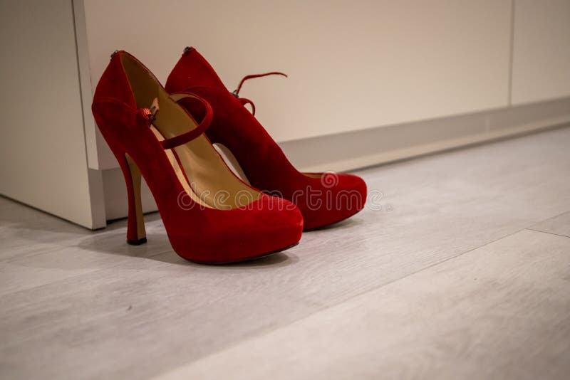 Red High Heels on a White Wood Floor in Front of a Closet To Dress Up ...