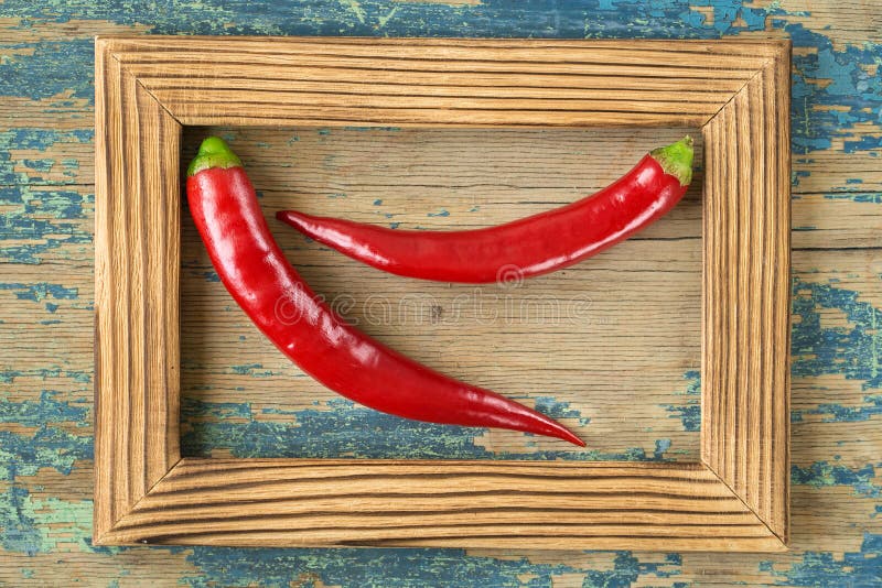 Red hot pepper on rustic wooden background.