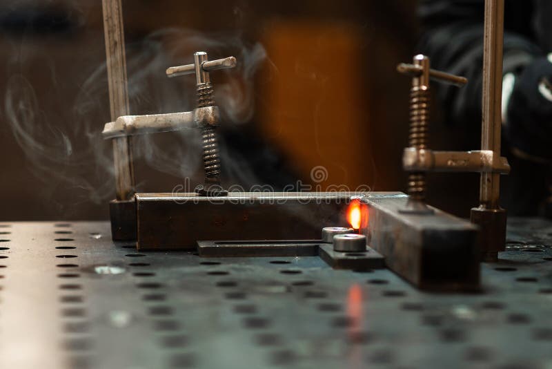 A Red Hot Weld between Two Pieces of a Metal Pipe Cools Down Stock