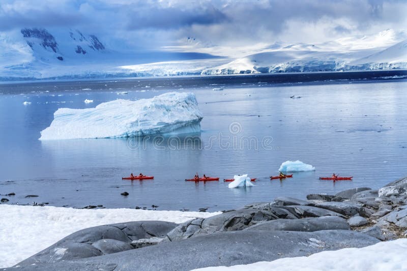 Red Kayaks Iceberg Snow Mountains Blue Glaciers Damoy Point Antarctica