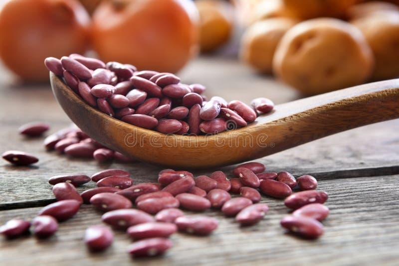 Red kidney beans. Dried red kidney beans in a wooden spoon royalty free stock photography