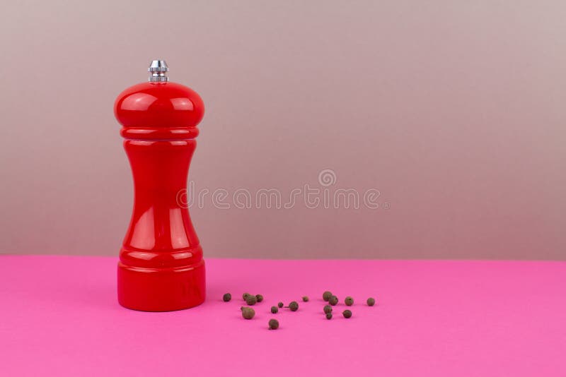 Red Kitchen Pepper Shaker for Ground Pepper on the Table Stock Photo
