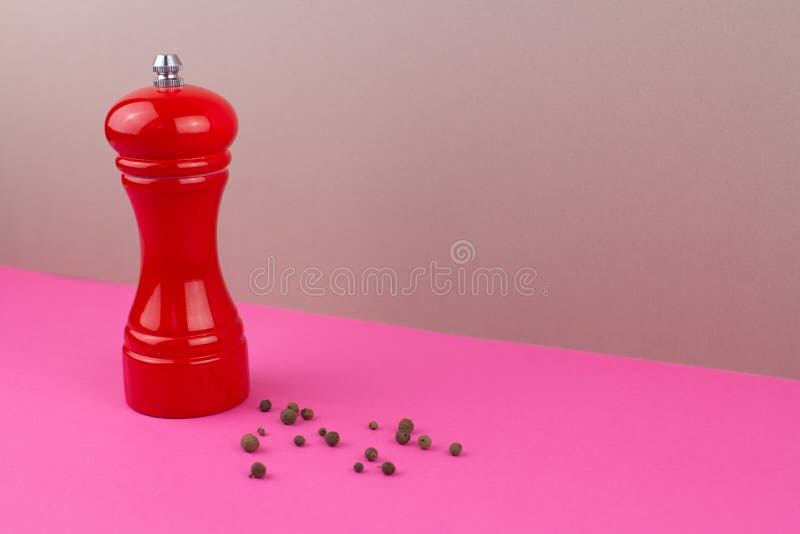 Red Kitchen Pepper Shaker for Ground Pepper on the Table Stock Image