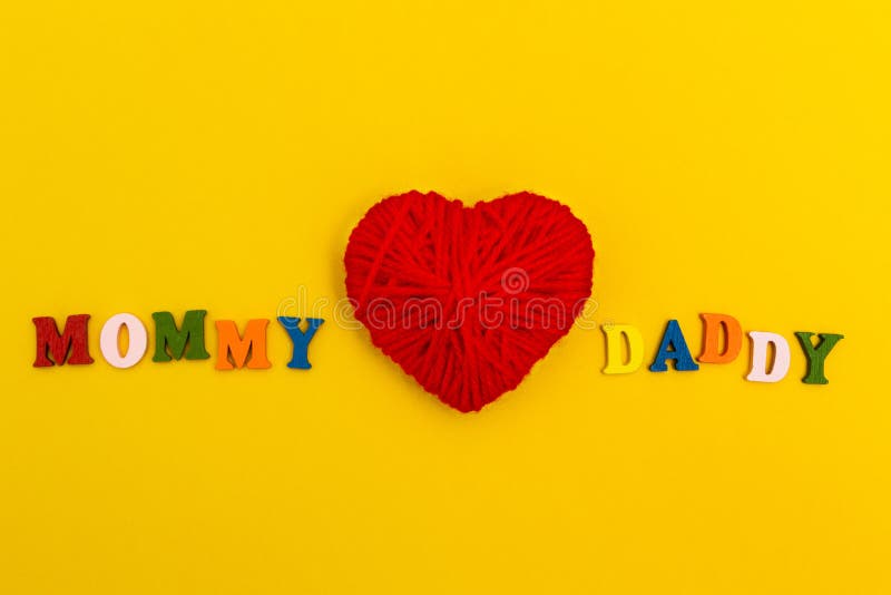 Red knitted heart on a yellow background, Mom loves Daddy