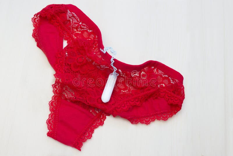 Red lace underwear pants and menstruation tampon for blood period. Woman hygiene conception photo. Soft tender protection for woma. N critical days royalty free stock image Red lace underwear pants and menstruation tampon for blood period. Woman hygiene conception photo. Soft tender protection for woma. N critical days royalty free stock image