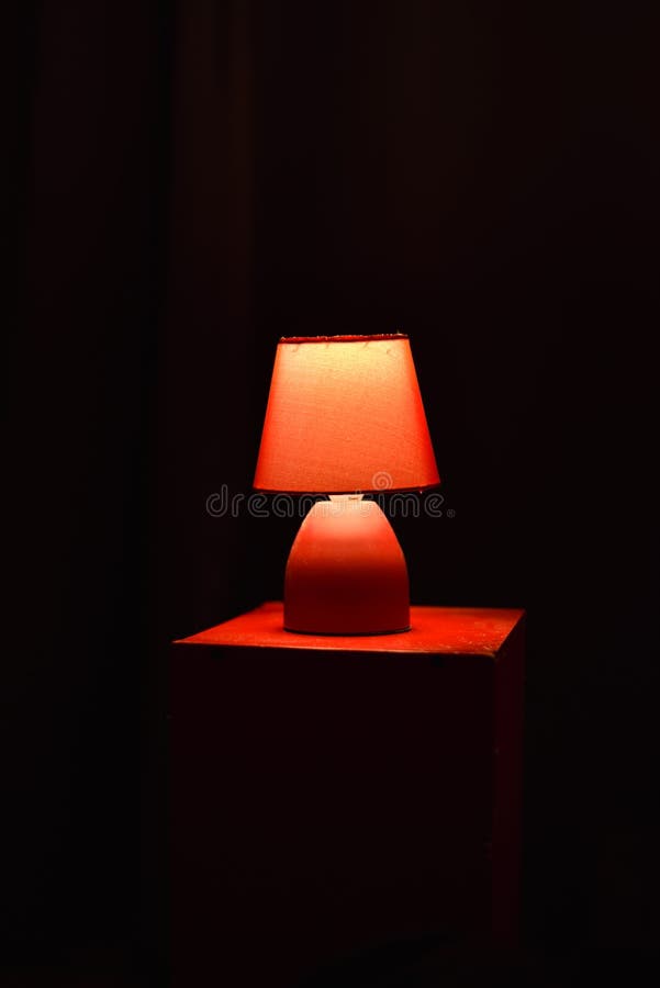 Red Lamp with Black Background in an Apartment in Paris Stock Photo