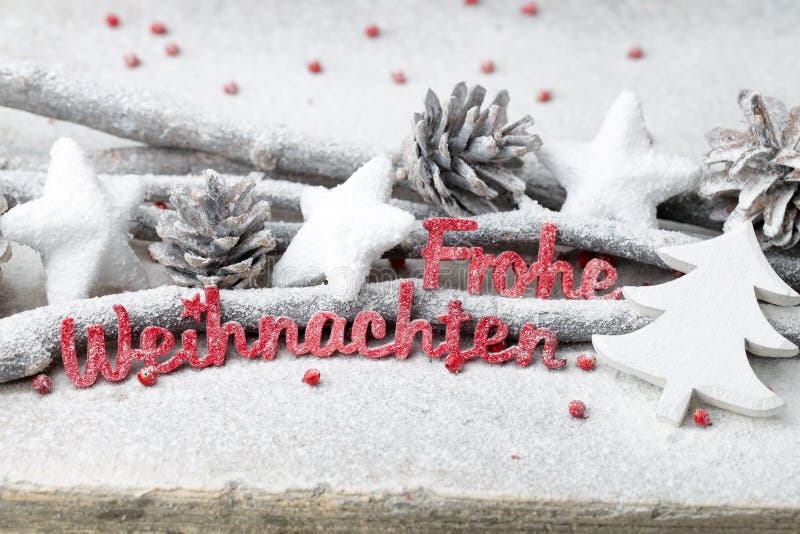 Red letters with german Frohe Weihnachten means Merry Christmas.