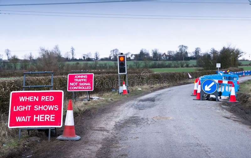 Red light traffic light on rural country road UK roadworks