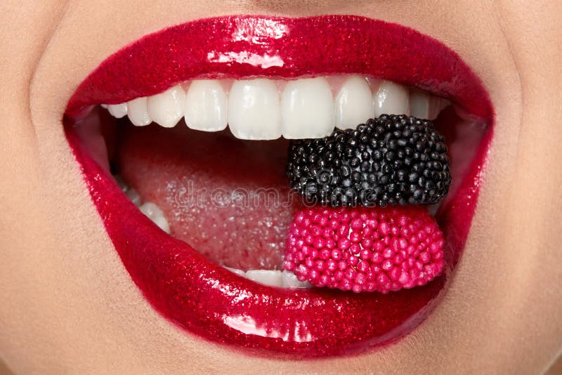 Red Lips With Glitter Lipstick And Candy In White Teeth