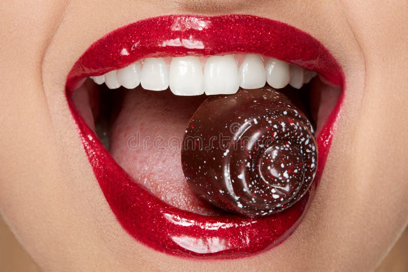 Red Lips With Glitter Lipstick And Candy In White Teeth