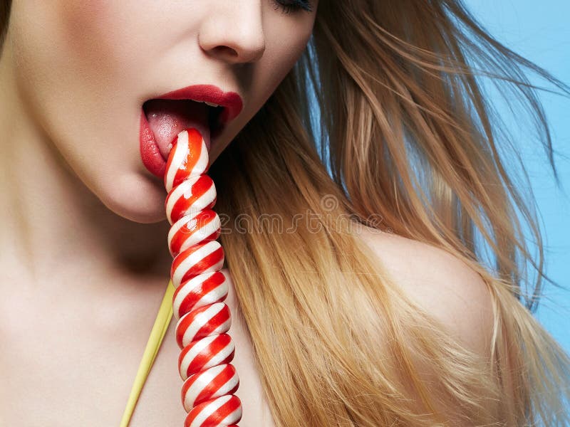 Red lips mouth and candy. Girl eating lollipop