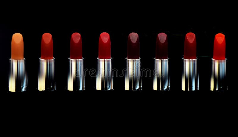 Red lipstick. Cosmetics on black background isolated. Lipsticks on black. High quality daily make up. Cosmetics artistry royalty free stock photography Red lipstick. Cosmetics on black background isolated. Lipsticks on black. High quality daily make up. Cosmetics artistry royalty free stock photography