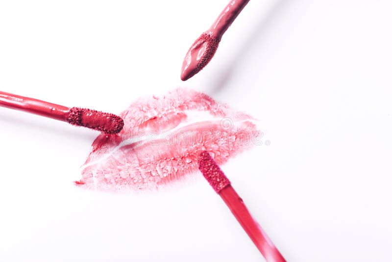Red Lipstick Kiss with Lipstick Brushes on White Background Stock Photo