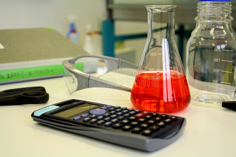 Red liquid in beaker on the table in laboratory