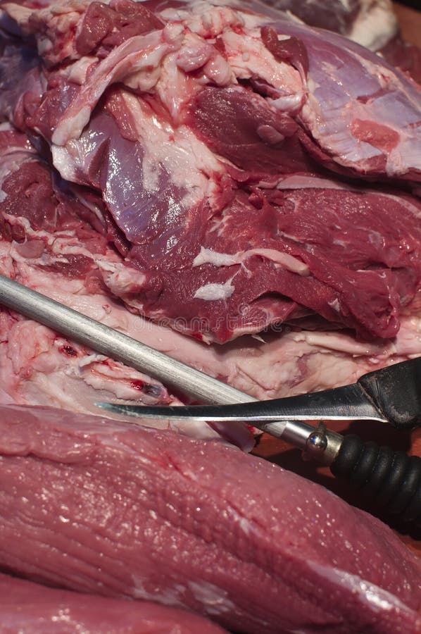 Red meat with bucher knife stock image. Image of butcher 65936355