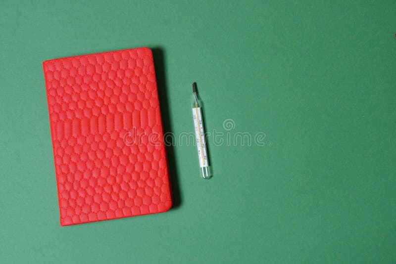Red Medical Notepad on a Green Background with a Gradient Stock Photo