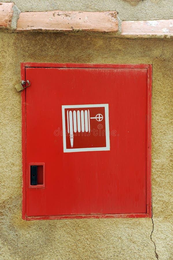 Red metal door of the container of a hydrant hose for extinguishing fires. stock image