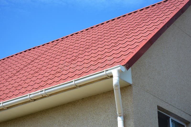 Red Metal Roof with White Plastic Rain Gutter. Stock Photo Image of