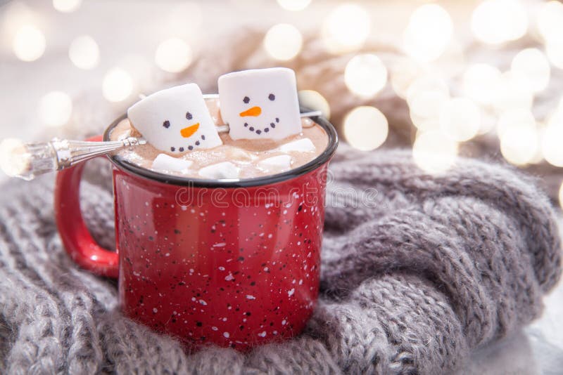 Red thermos next cup with hot chocolate with marshmallows on table with  snow outside Stock Photo - Alamy