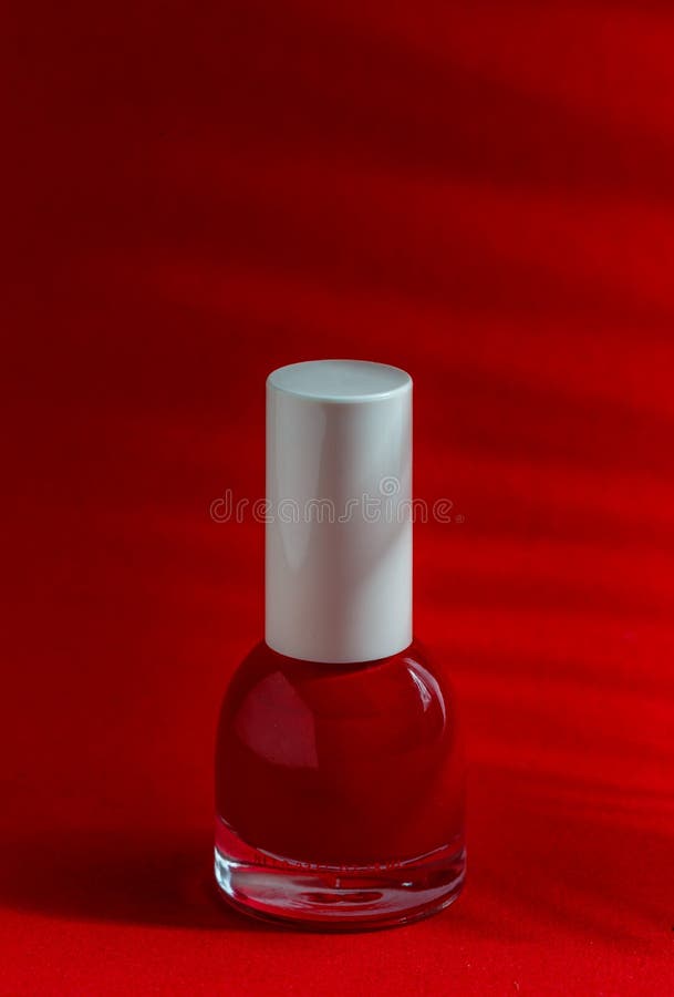 Red nail polish bottles on red background stock photo