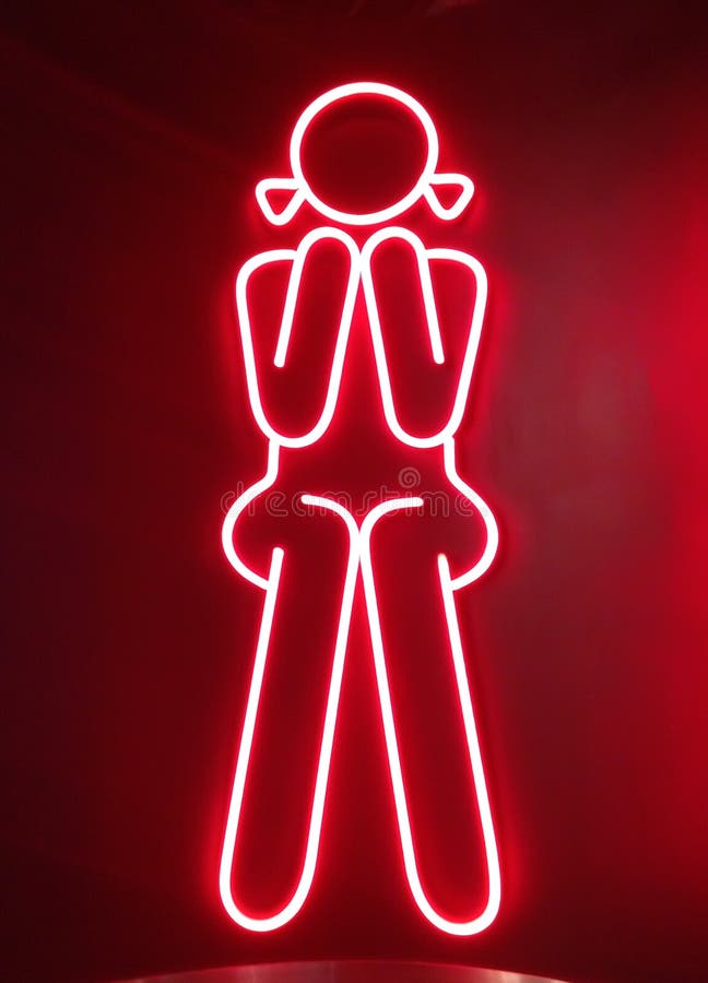 Red neon for girl sitting in front of female toilets