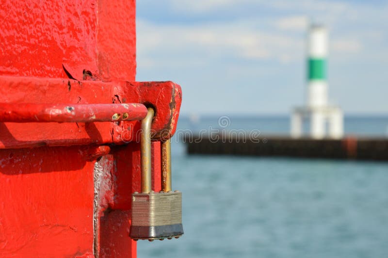 This is the red North Pier Lighthouse lock on the beautiful Lake Michigan in Kenosha, WI. There is also a green and white lighthouse in the background. This is the red North Pier Lighthouse lock on the beautiful Lake Michigan in Kenosha, WI. There is also a green and white lighthouse in the background.