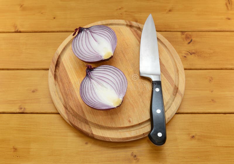 Red Onion Cut in Half with a Knife on a Cutting Board Stock Photo Image of edible, nutritious