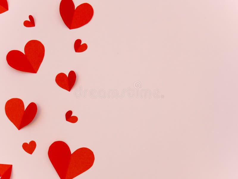 Red paper heart valentine day card on pink background with copy space for text