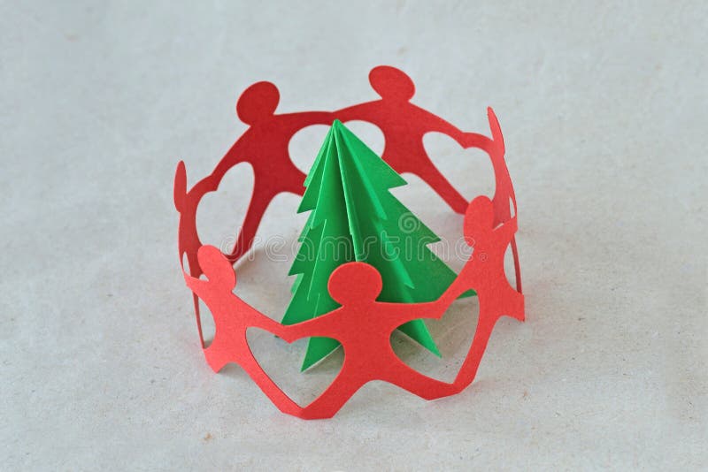 Red paper people in a circle around a tree on recycled paper background - Ecology concept stock photo Red paper people in a circle around a tree on recycled paper background - Ecology concept stock photo