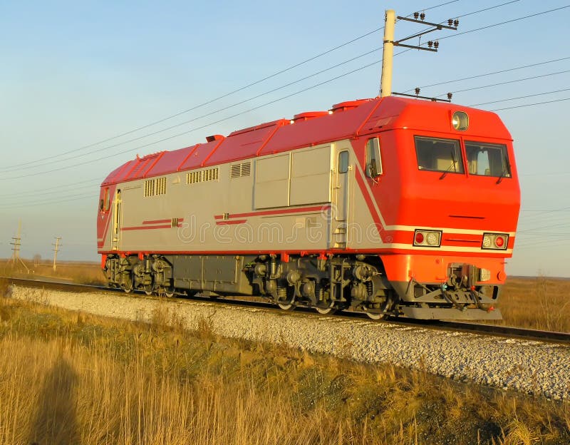 Red passenger locomotive at evening