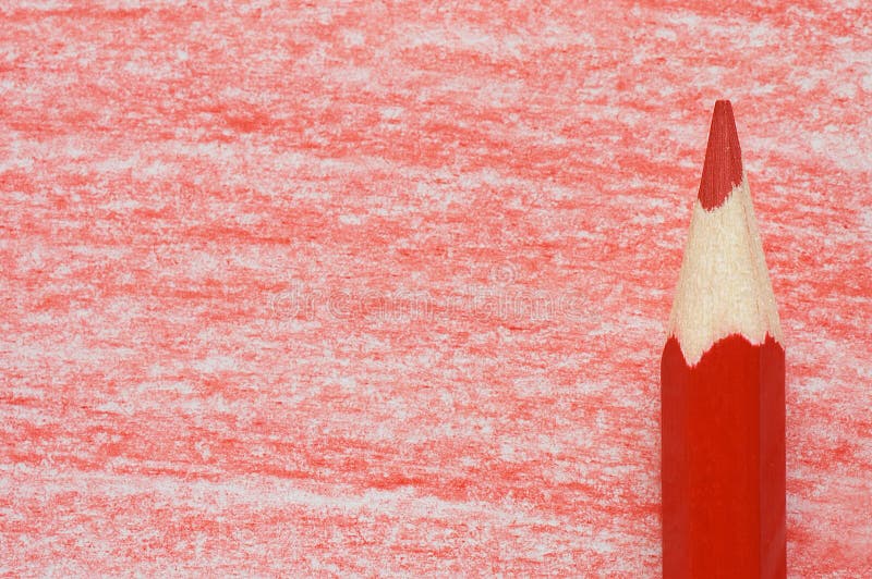 Red pencil with coloring on a paper