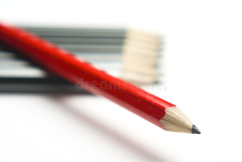 Red pencil crossing grey group diagonally stock photo