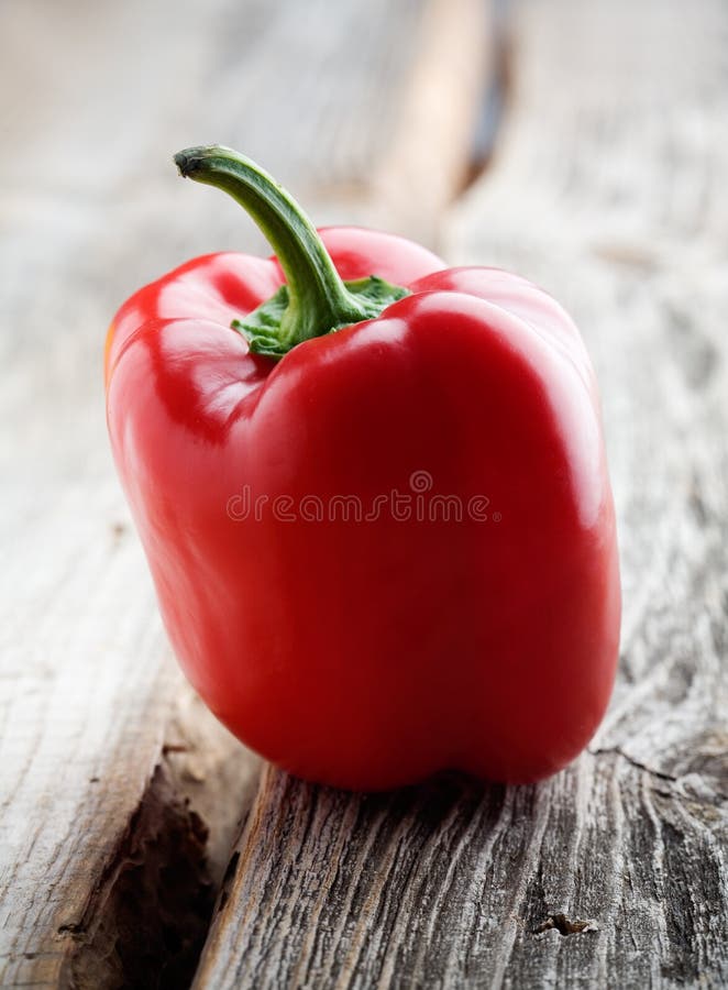 Fresh red pepper on wooden background, selective focus