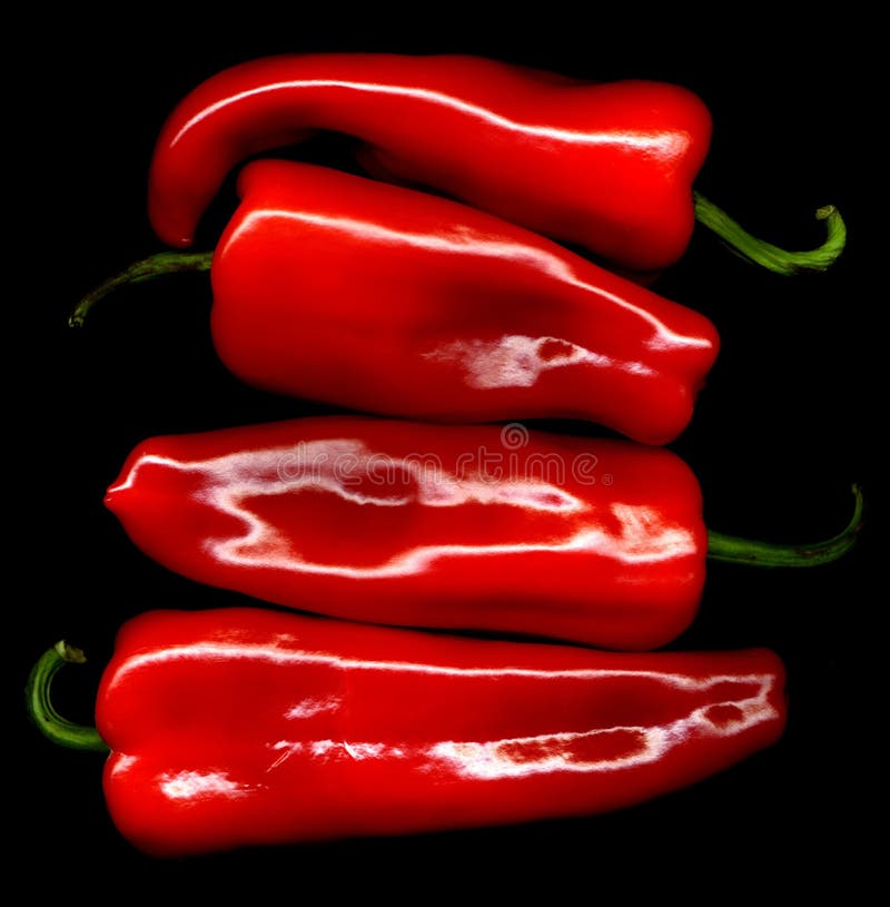Four fresh red sweet pepper on black background. Four fresh red sweet pepper on black background