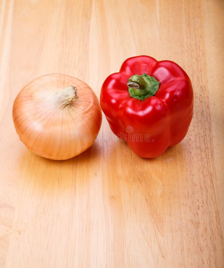 Red Pepper and Yellow Onion on Wood Table Stock Photo Image of wood