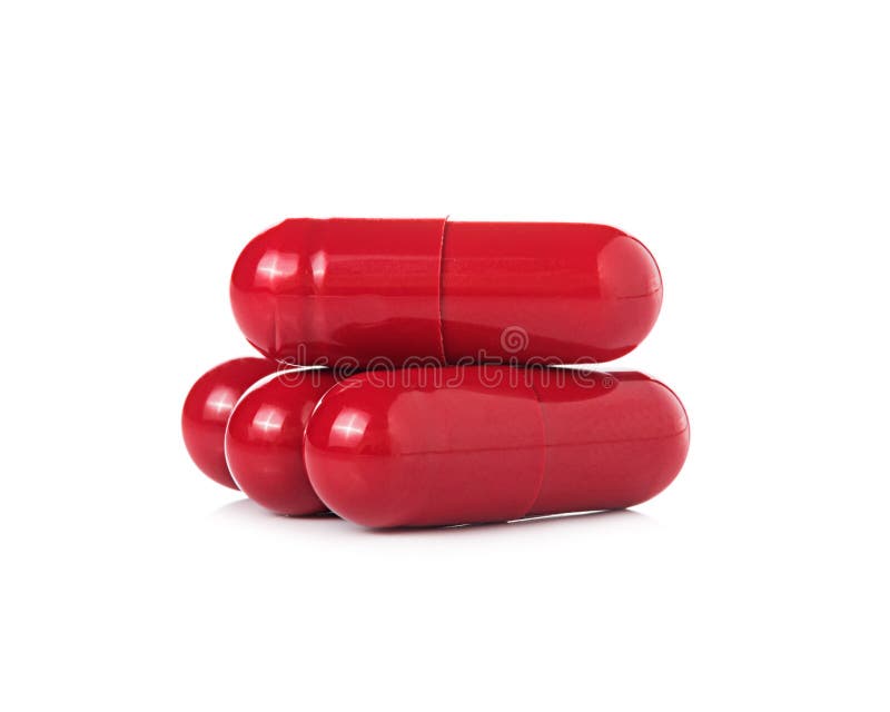 Red pill capsules on white background