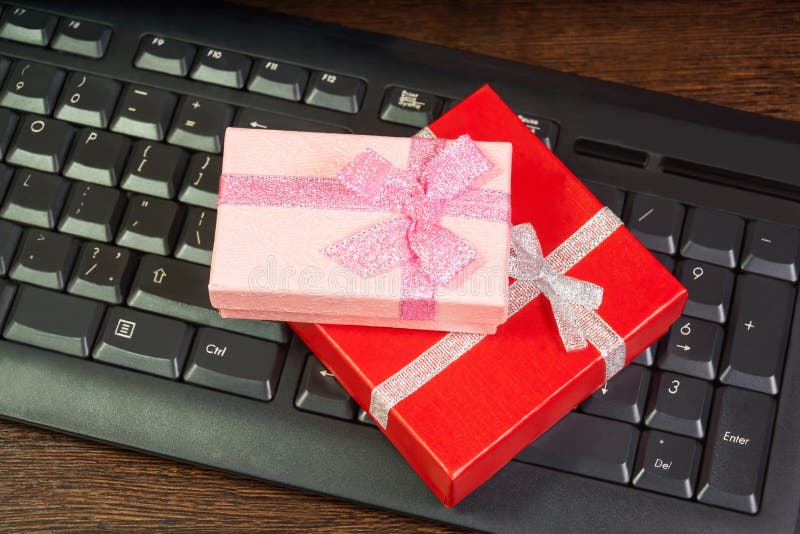 Red and pink gift box on computer keyboard royalty free stock image Red and pink gift box on computer keyboard royalty free stock image