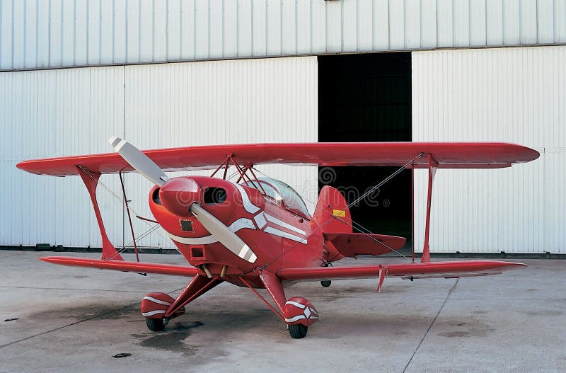 Red plane and open hangar door royalty free stock photography