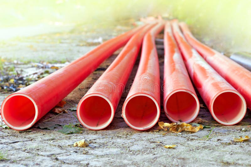 Red Plastic Communication Water Pipes on a Construction Site in Sunlight Stock Image Image of