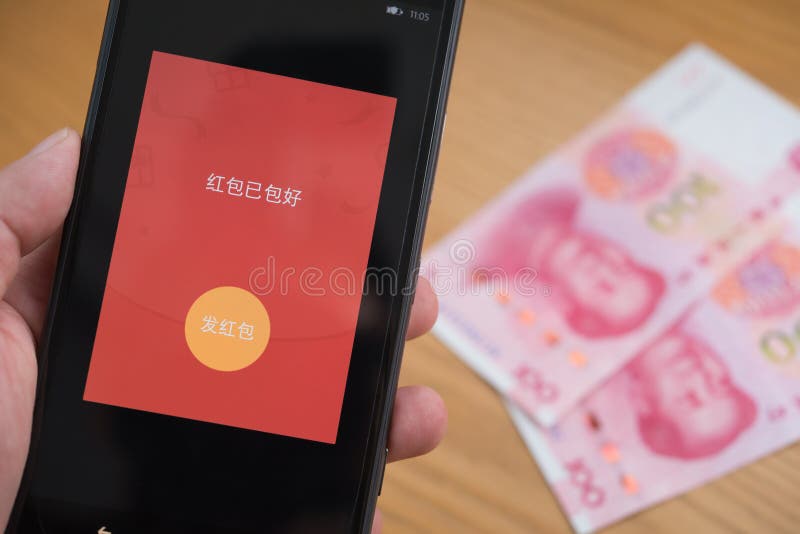 :a red pocket on mobile is ready to be sent out on WeChat for Chinese new year with RMB on background
