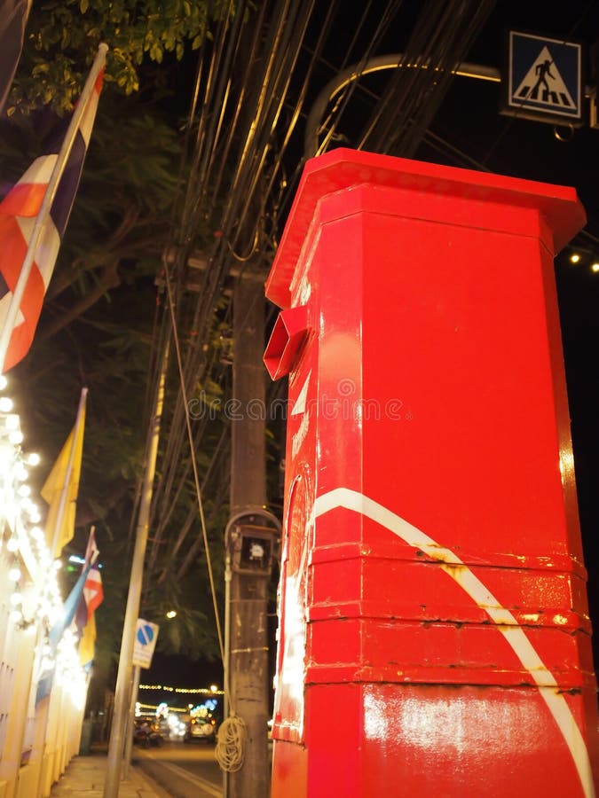 Red post box on the sidewalk on public roads in the urban area stock image Red post box on the sidewalk on public roads in the urban area stock image