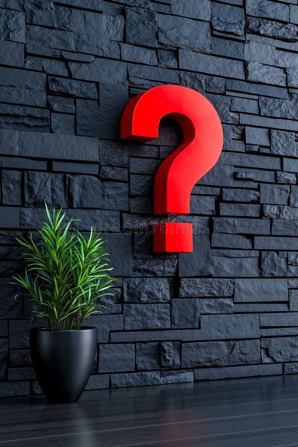 A red question mark on a black wall next to a potted plant stock photography