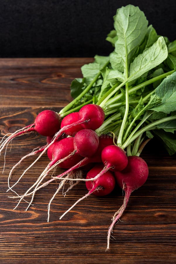 Red radish on dark wooden background